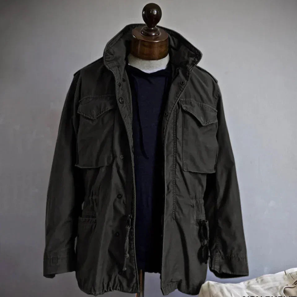 Durable men's utility jacket with multi-pocket design, adjustable waist, and robust snap closure for versatile wear.