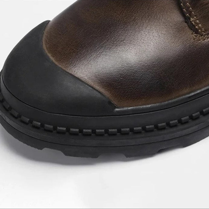 Rugged sole of men's vintage winter boots, showing grip and durable construction. Warm leather upper.