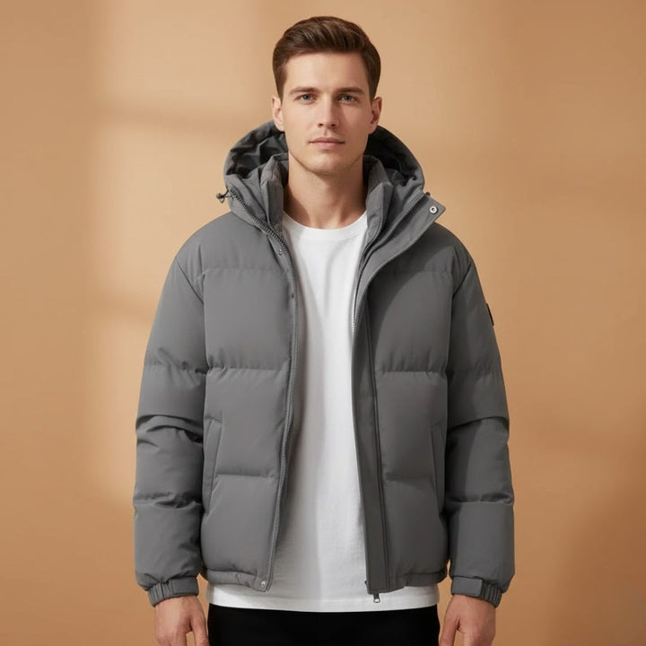 Versatile men's quilted puffer jacket with hood. Zip-up design for casual wear & winter adventures.