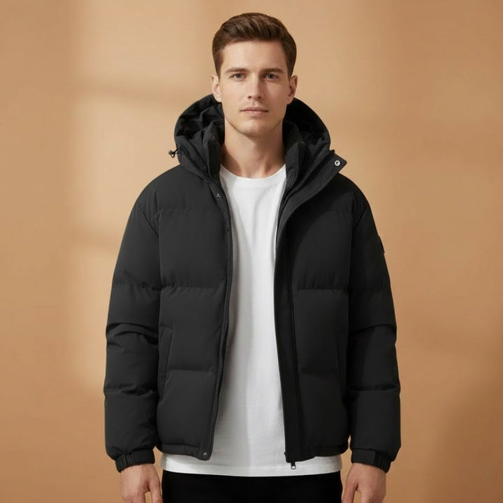 Side view of men's hooded quilted jacket, showing lightweight fit. Warm puffer outerwear for cold daily wear.