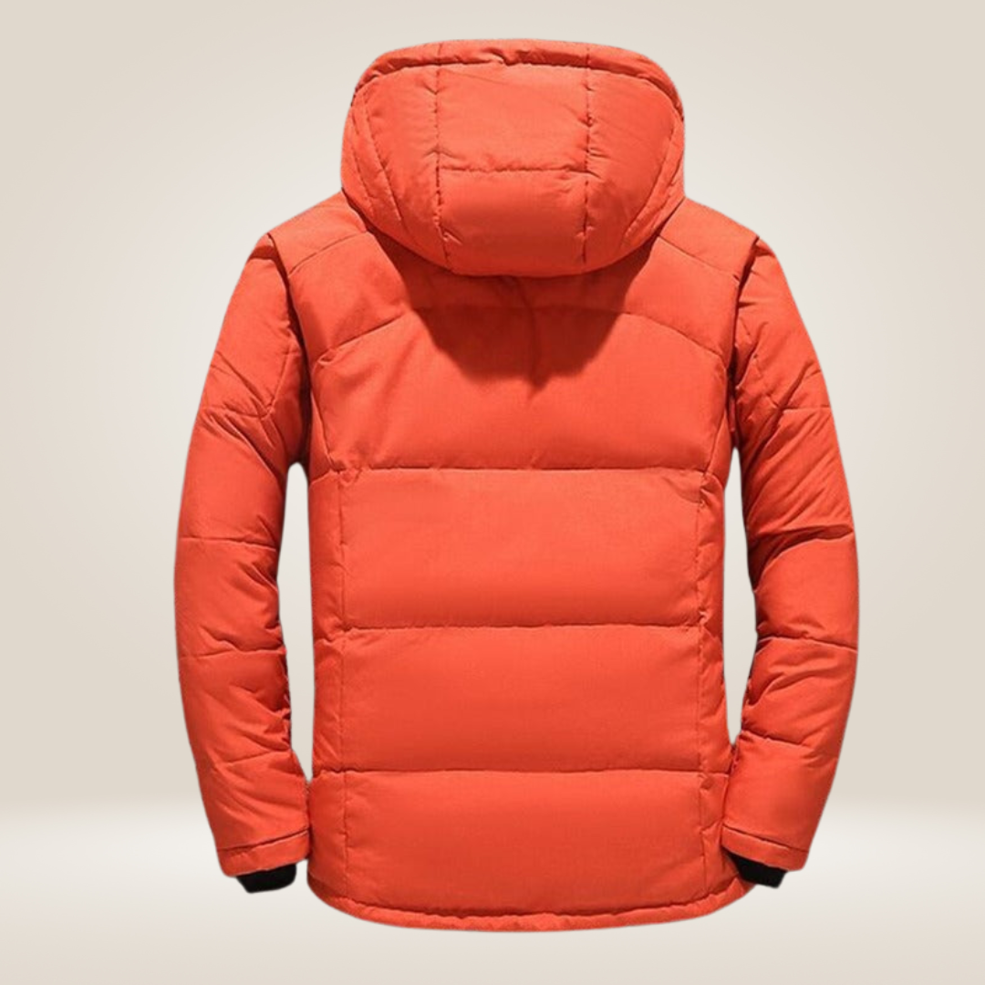 A man wearing a warm insulated winter jacket, enjoying a snowy landscape, outdoor wear