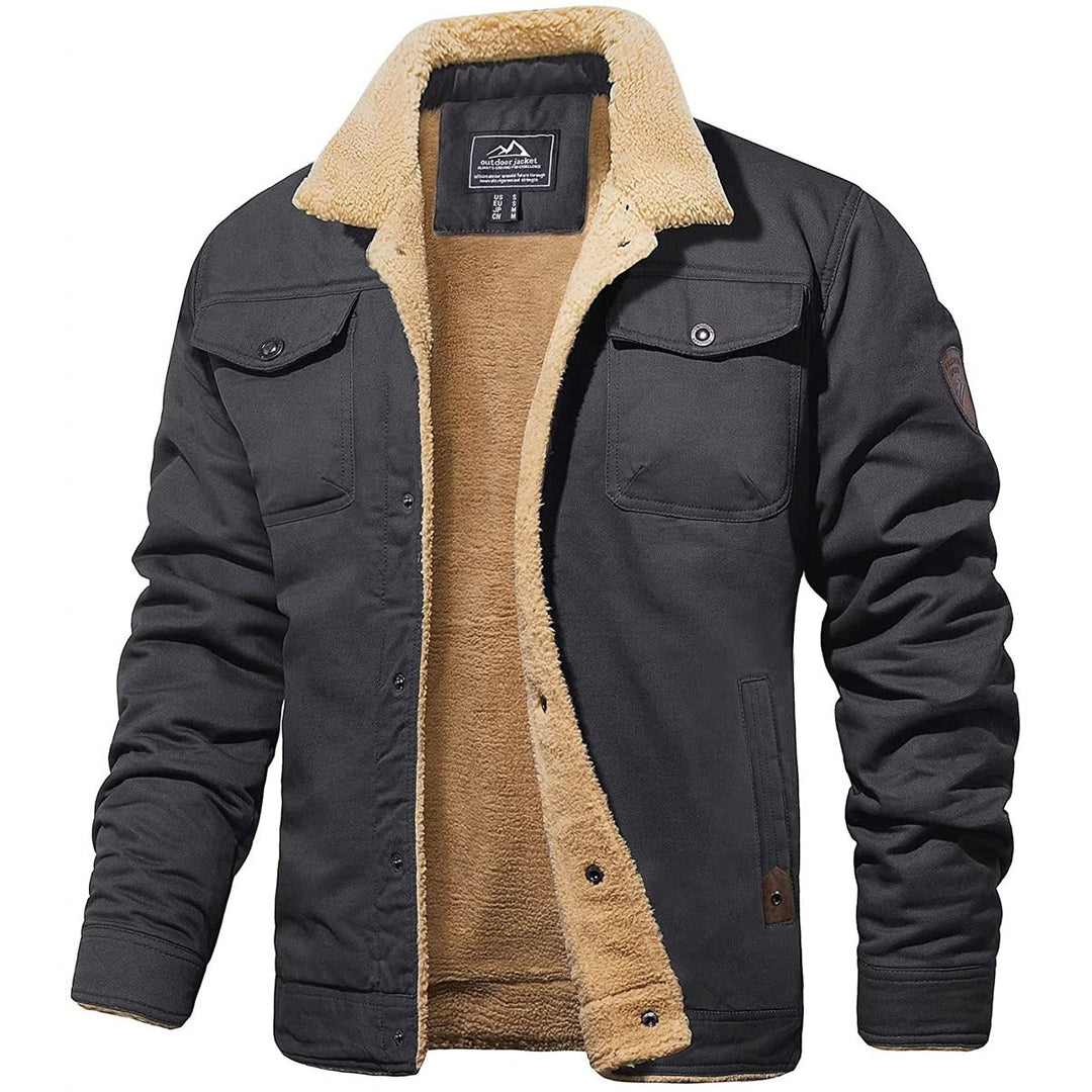 Detail of the zipper and pockets on a men's warm sherpa-lined cold weather jacket, high quality.