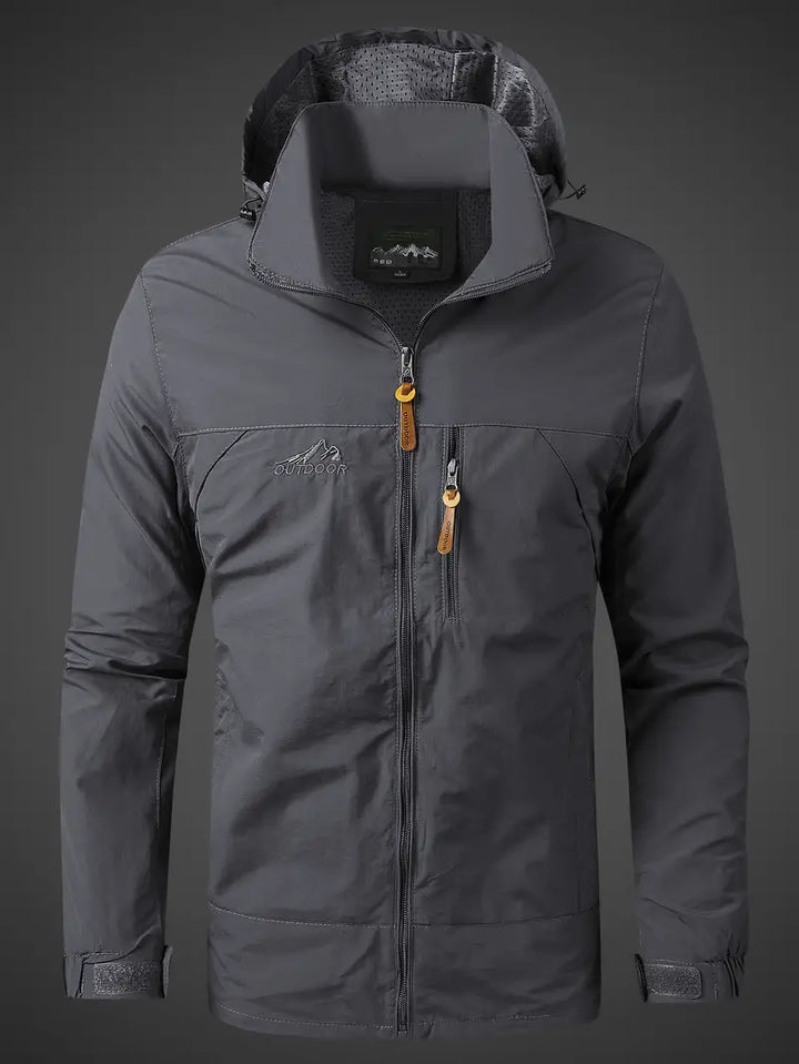 Packable men's travel jacket. Lightweight, hooded, waterproof rain gear & windbreaker for outdoor trips.