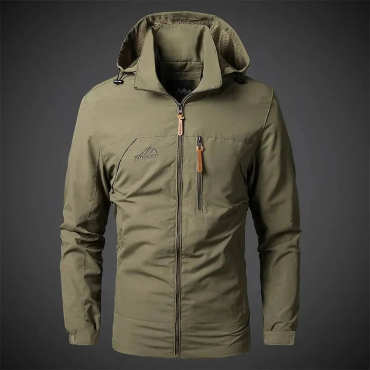 Close-up of embroidered detail on a men's waterproof wind jacket, perfect lightweight outerwear for spring.