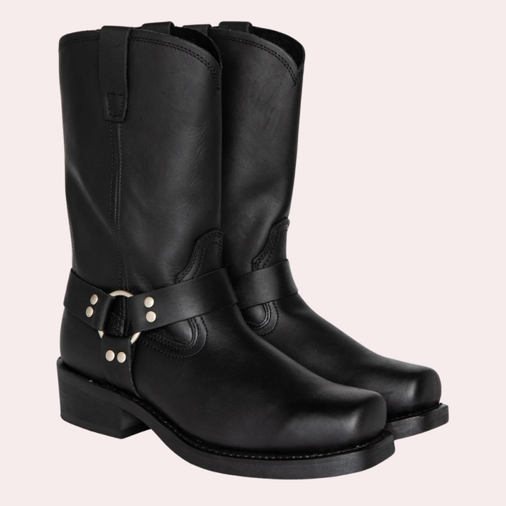 Stylish brown leather cowboy boots for men, with a prominent strap detail, showcasing a classic western footwear look.