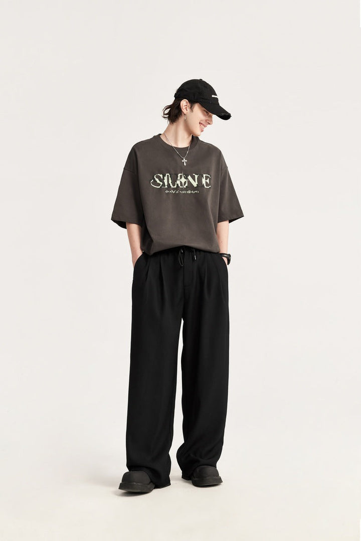 Stylish men's wide leg pants, versatile for casual or smart-casual outfits. Drawstring waist.