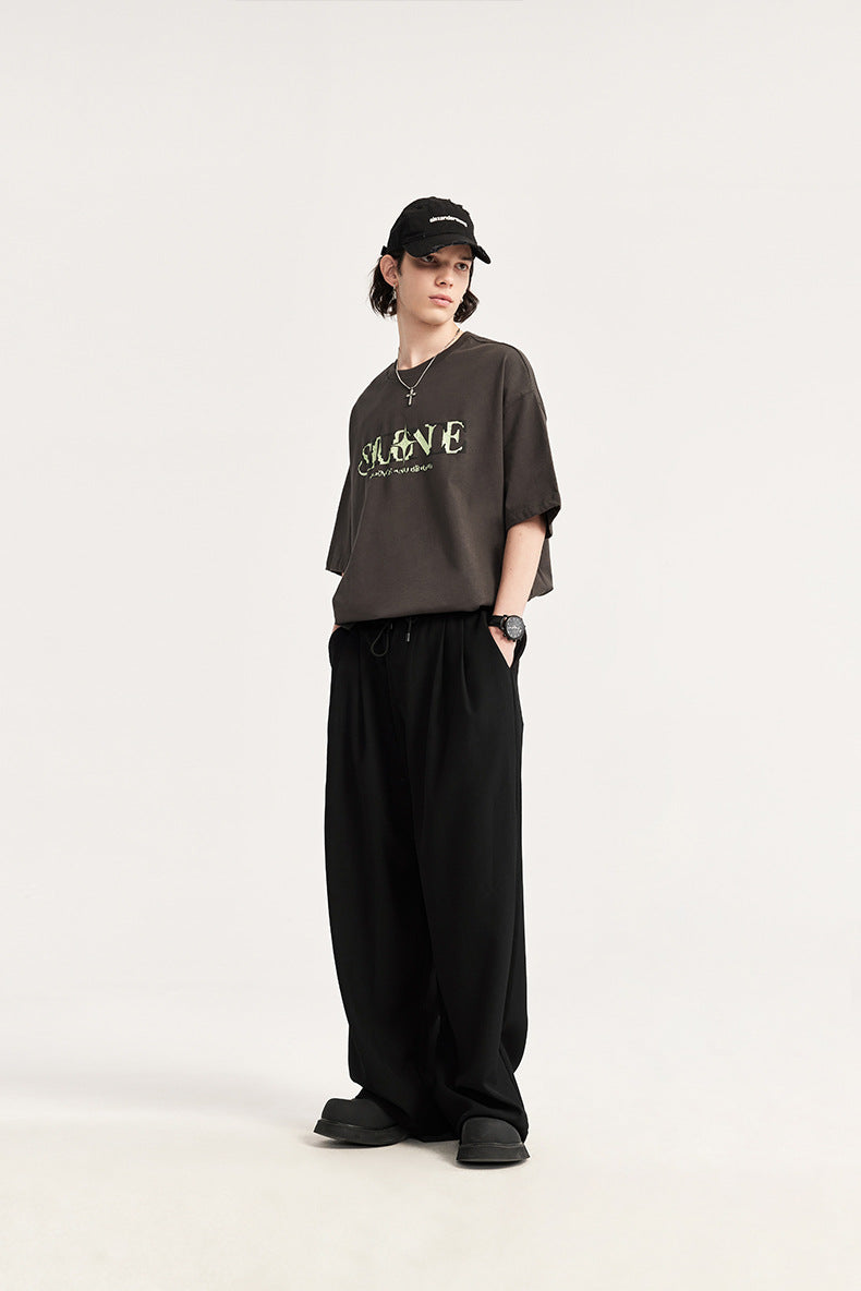 Comfortable men's wide leg drawstring chino trousers featuring elegant pleats & a relaxed fit.