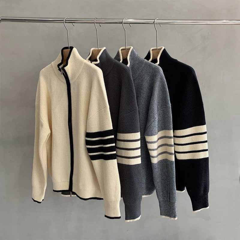 Modern men's zip-up sweater featuring prominent striped long sleeves. Fashionable casual knitwear outerwear.