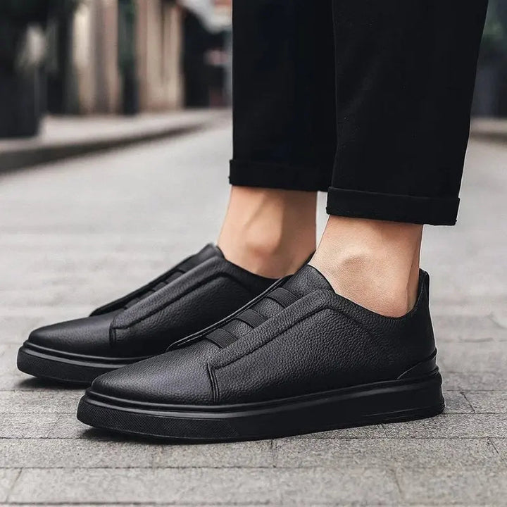 Athletic-inspired men's slip-on trainers with secure loop lacing for effortless style & active comfort.