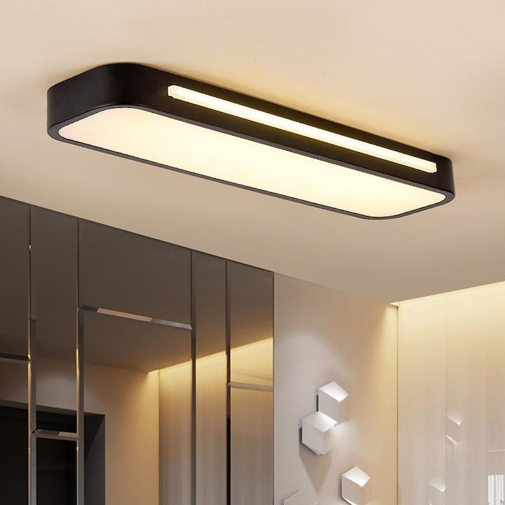 Minimalist long LED ceiling light for modern living rooms. Sleek Nordic design, bright illumination.