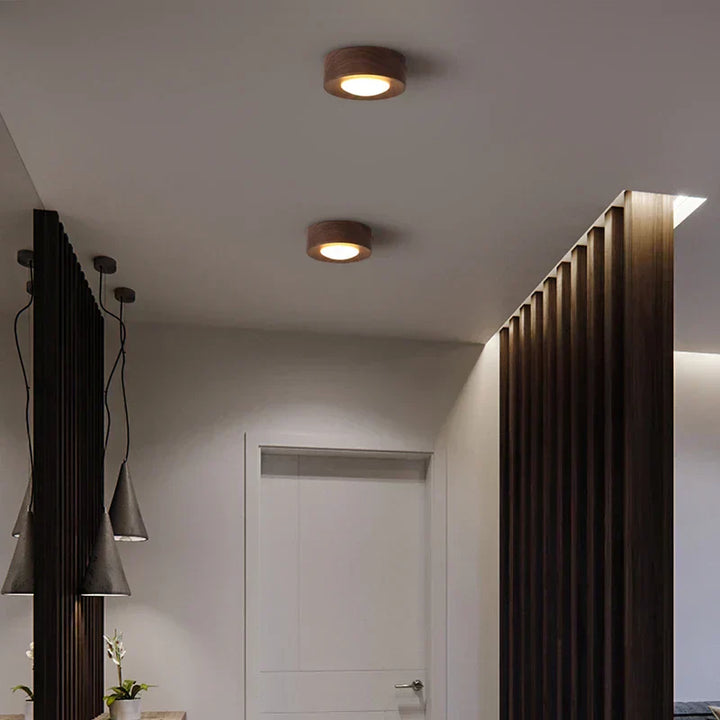 Modern round wooden LED ceiling light crafted from walnut, delivering minimalist and energy-efficient ambient light.