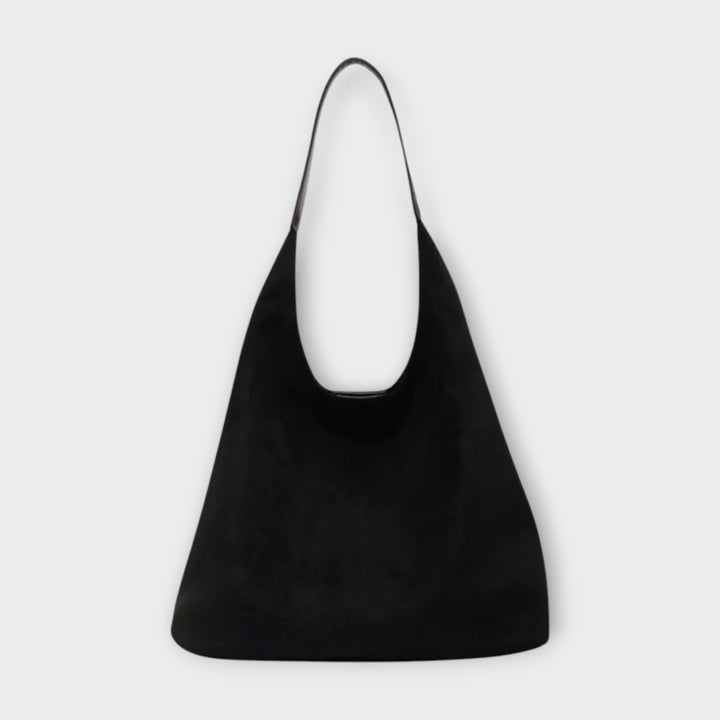Everyday crossbody bag for women, featuring a minimalist aesthetic and vegan leather material.
