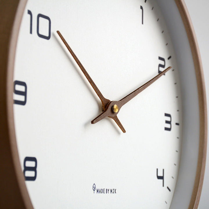 Elegant round wooden frame wall clock, silent quartz movement for serene modern home environments.