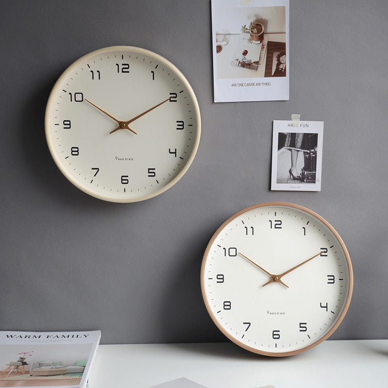 Round minimalist wall clock with a warm wooden frame & silent operation, fitting all modern decor styles.