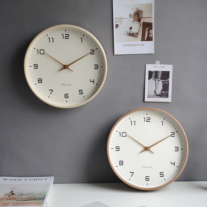 Round minimalist wall clock with a warm wooden frame & silent operation, fitting all modern decor styles.