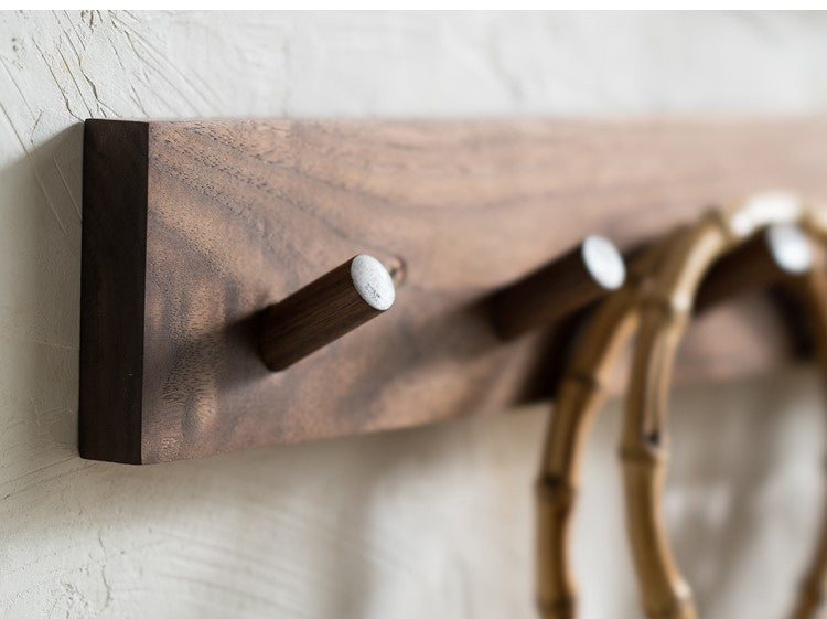 Minimalist wooden wall coat rack in walnut finish for zen home organization & entryway storage.