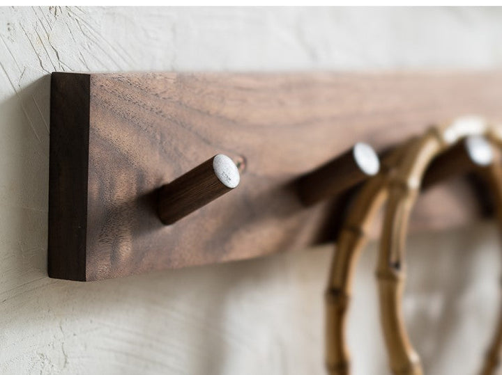 Minimalist wooden wall coat rack in walnut finish for zen home organization & entryway storage.
