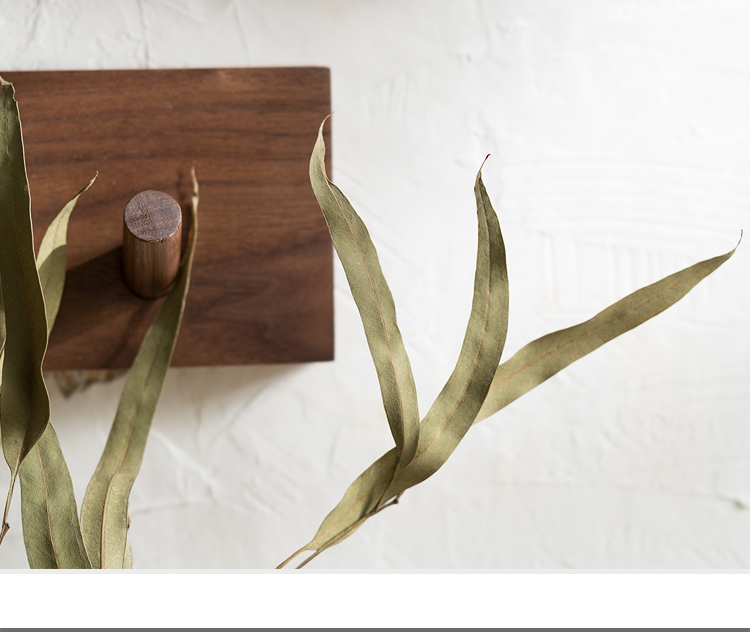 Space-saving wall organizer with handmade wooden hooks, ideal for entryway or bedroom storage.