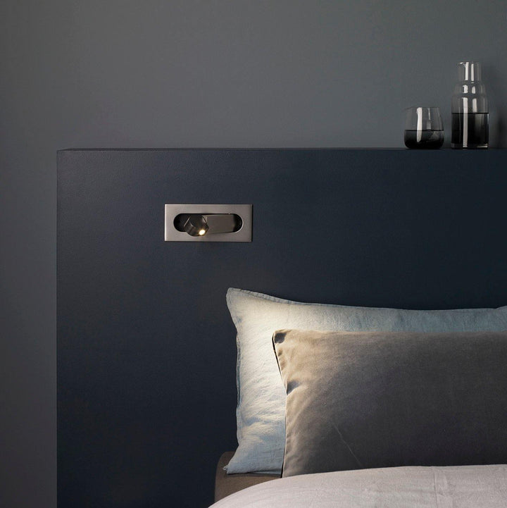 Modern LED wall lamp with flexible arm for bedside and reading convenience.