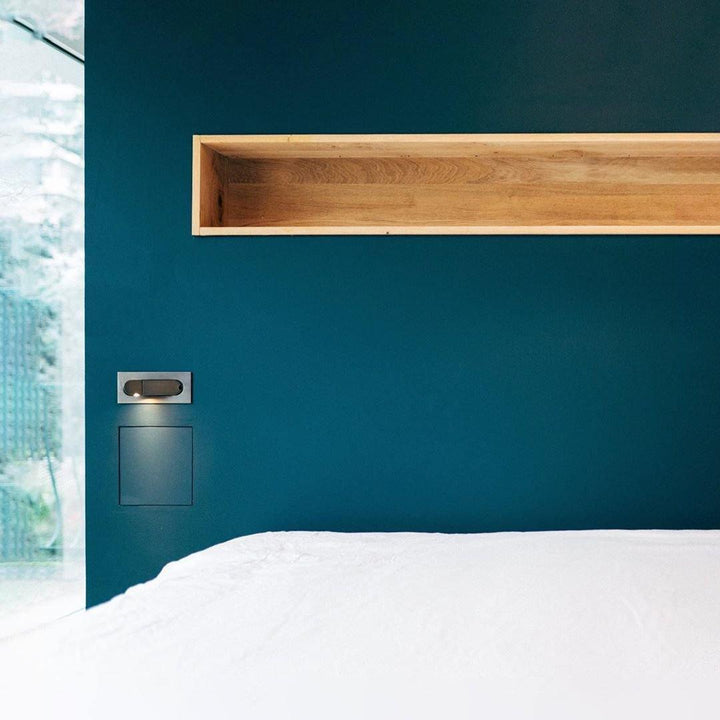Sleek adjustable LED reading light, modern design for bedroom functionality.