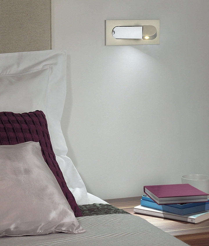 Sleek LED wall light, modern and flexible for bedroom task lighting.