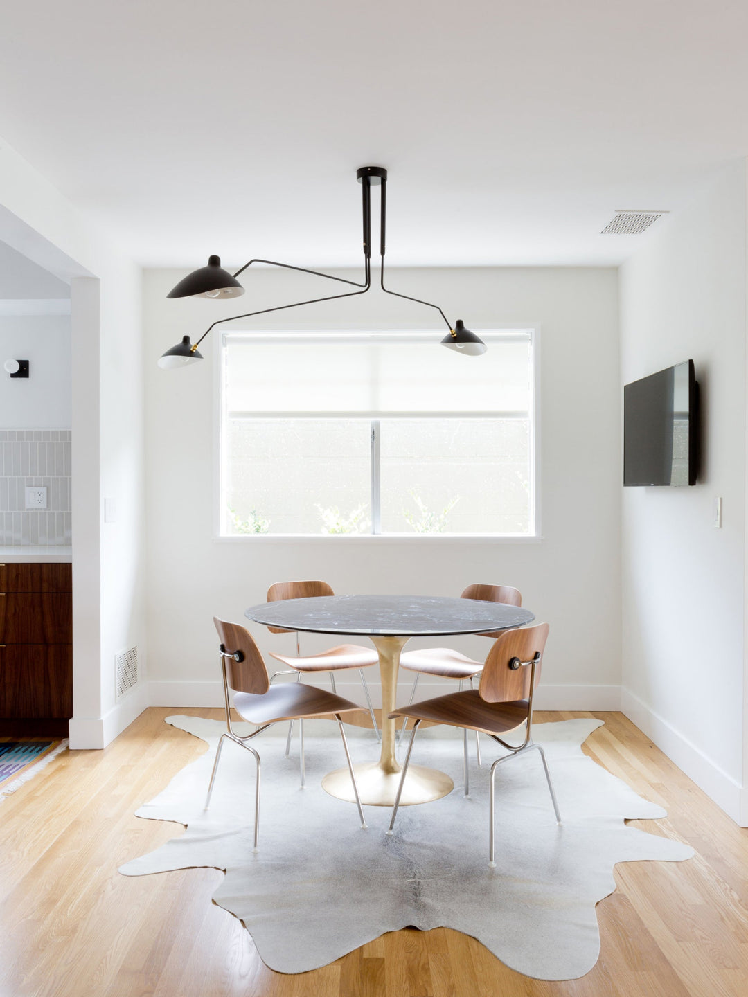 Adjustable multi-arm ceiling fixture, a designer piece for elegant modern homes.
