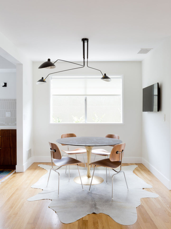 Adjustable multi-arm ceiling fixture, a designer piece for elegant modern homes.