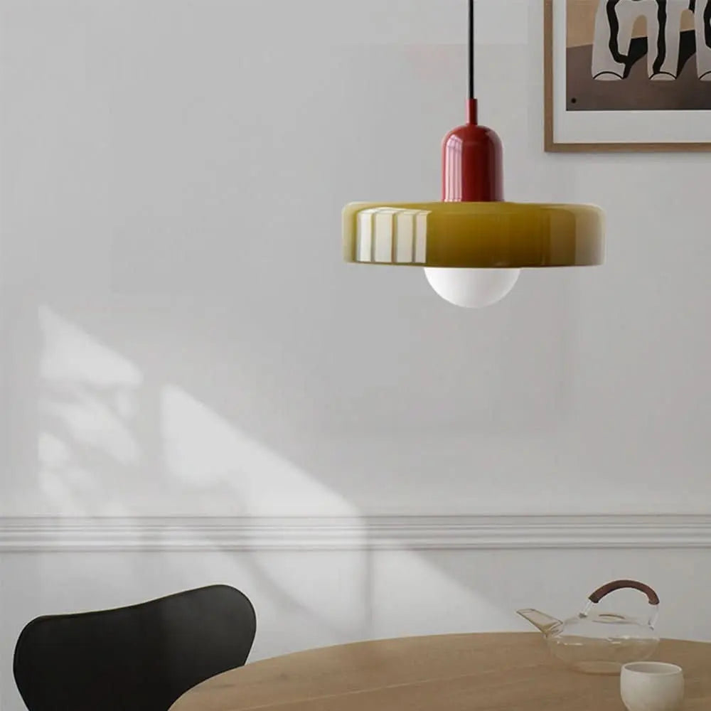 Elegant ceiling light with a round colored glass shade, perfect for modern homes.