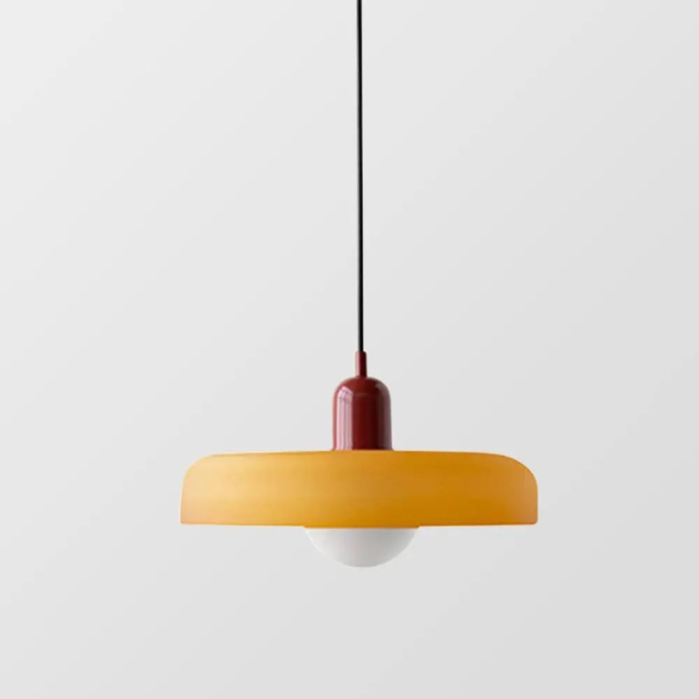 Modern decorative pendant light, colored glass shade, ideal for refined living.
