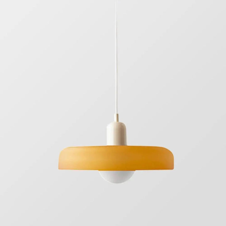 Round colored glass pendant, modern design, a focal point for contemporary interiors.