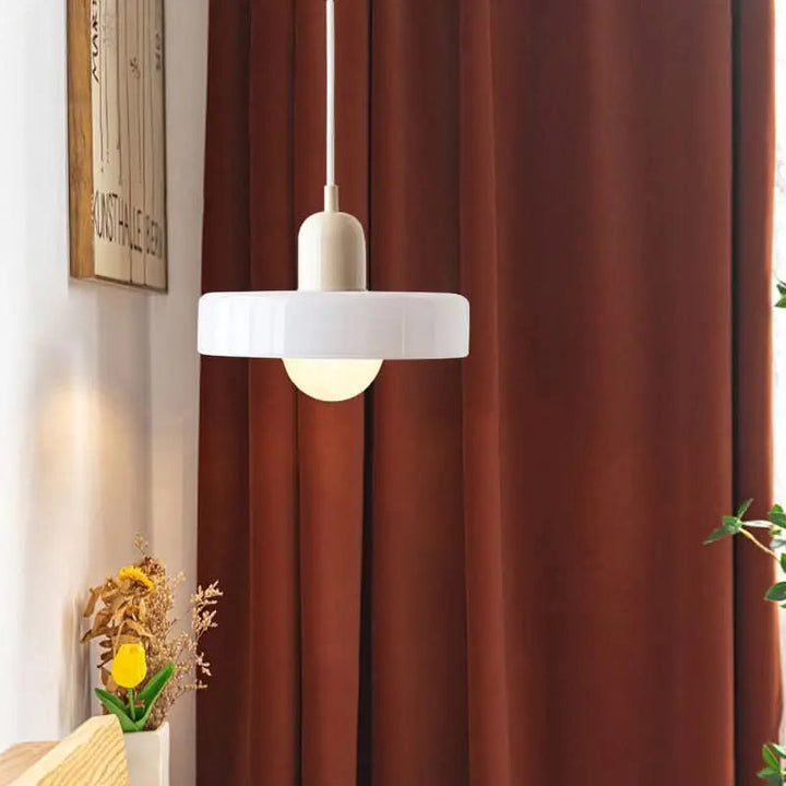 Modern ceiling light fixture, colored glass shade, for a bright and stylish space.