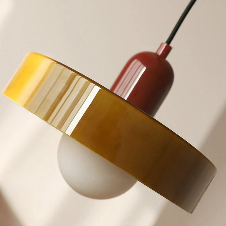 Vibrant colored glass pendant light, modern Bauhaus design for elegant living areas.