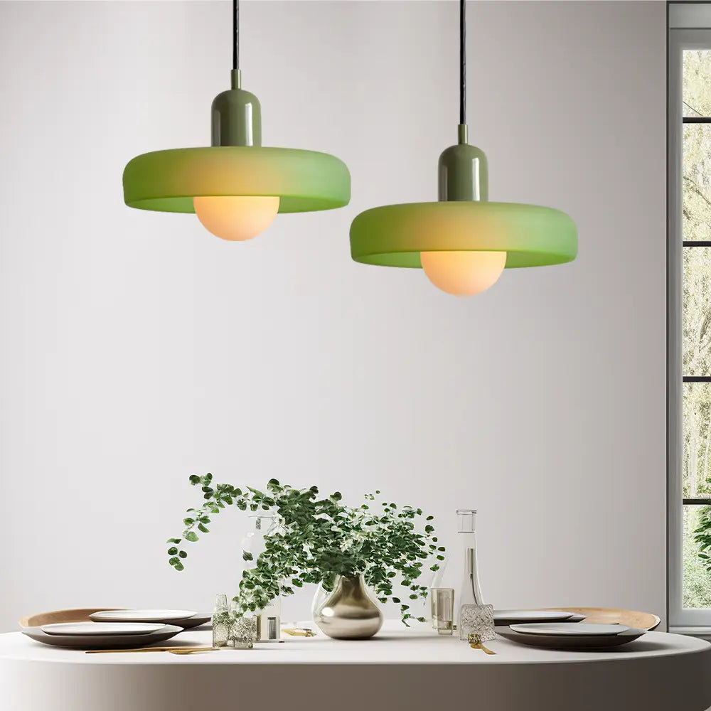 Modern pendant light with colored glass, adjustable for optimal lighting in any setting.