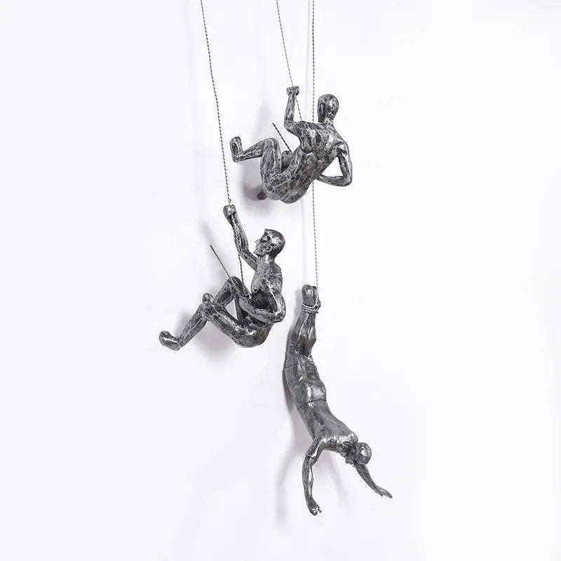Modern climbing figures wall sculpture set for unique living room decor.