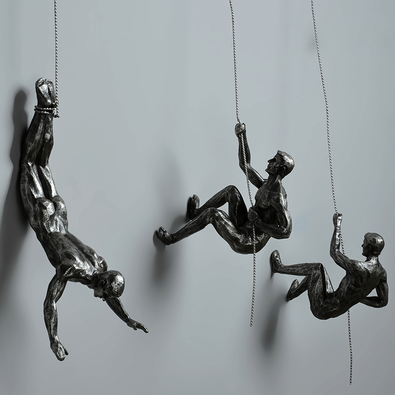 Modern home accent: Climbing figures wall sculpture set for stylish decor.