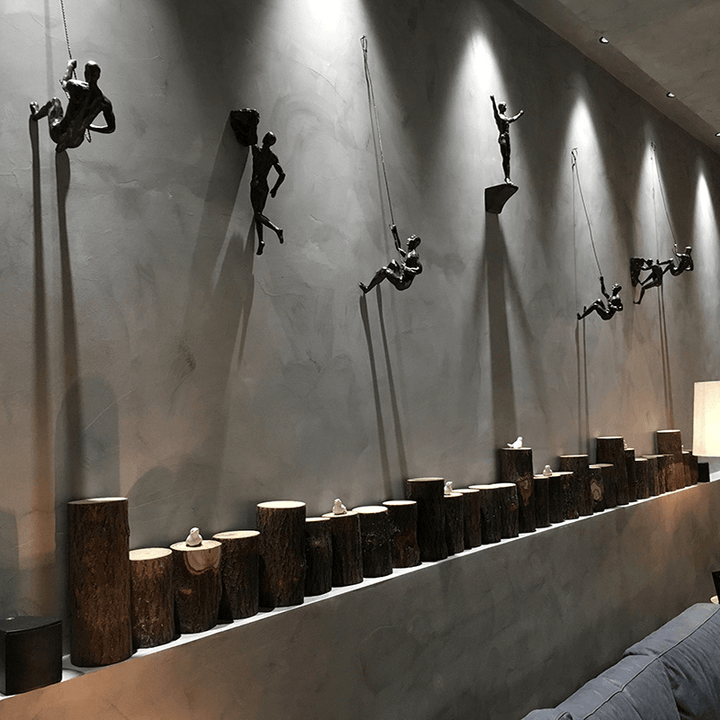 Set of modern climbing figures wall sculptures, perfect for office decor.