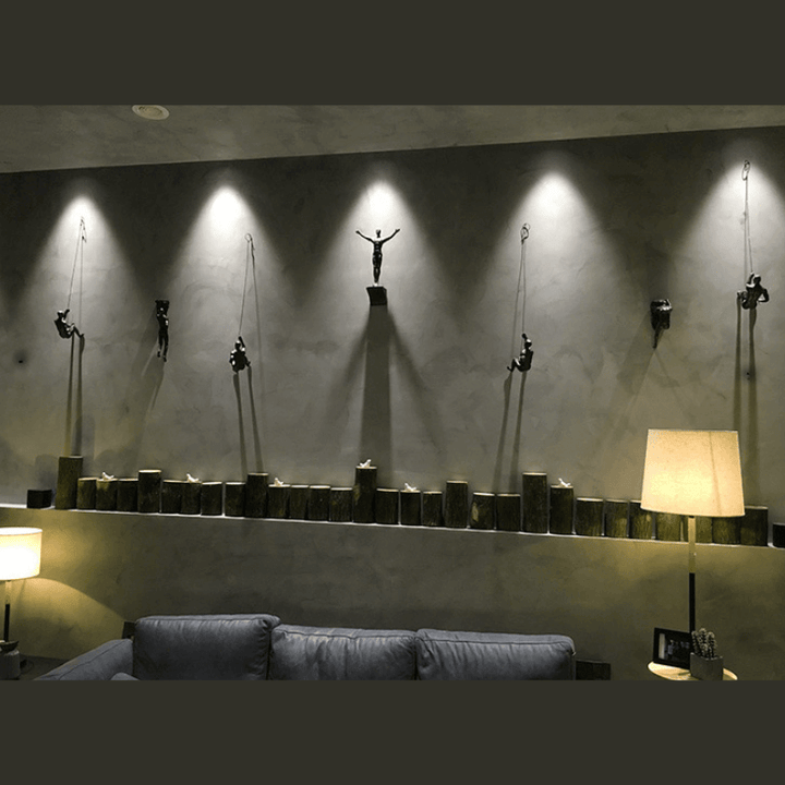 Elegant wall-mounted climbing figures art for a stylish home accent.