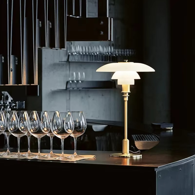 Sculptural Danish LED desk lamp, warm ambient glow, enhances modern decor and home lighting.
