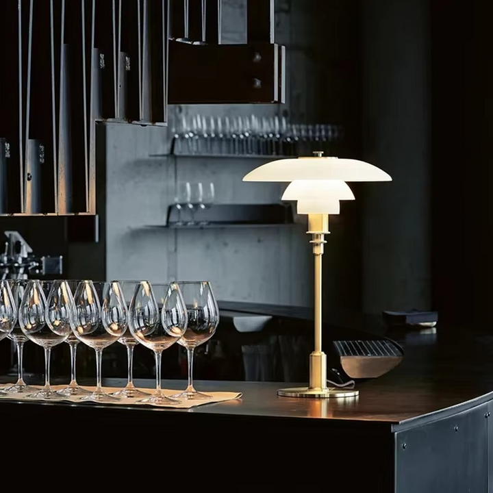 Sculptural Danish LED desk lamp, warm ambient glow, enhances modern decor and home lighting.