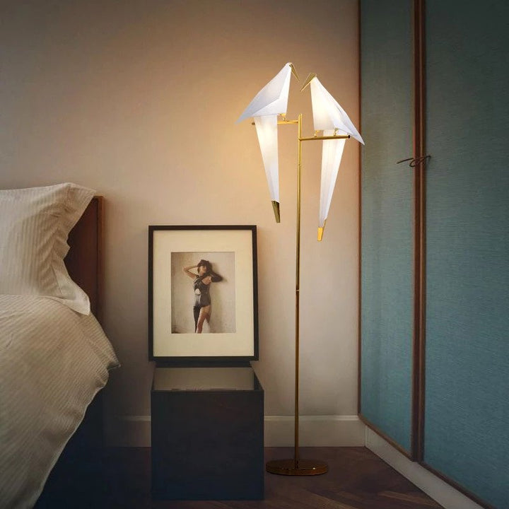 Artistic origami bird table lamp, a wireless decorative LED light with magnetic attachment for unique home ambient lighting.