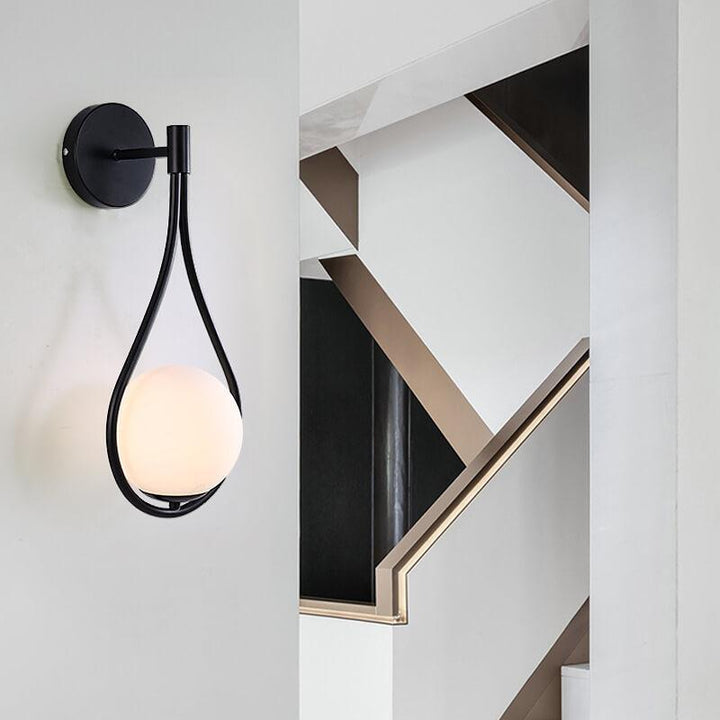 Contemporary LED globe wall light, perfect accent lighting for modern living rooms, bedrooms, or office spaces.