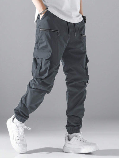 Dark grey men's tactical cargo pants, equipped with multiple secure zippered utility pockets.
