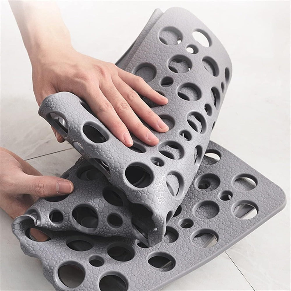 Grey non-slip bath mat, essential for a safe, modern bathroom; easy to clean.