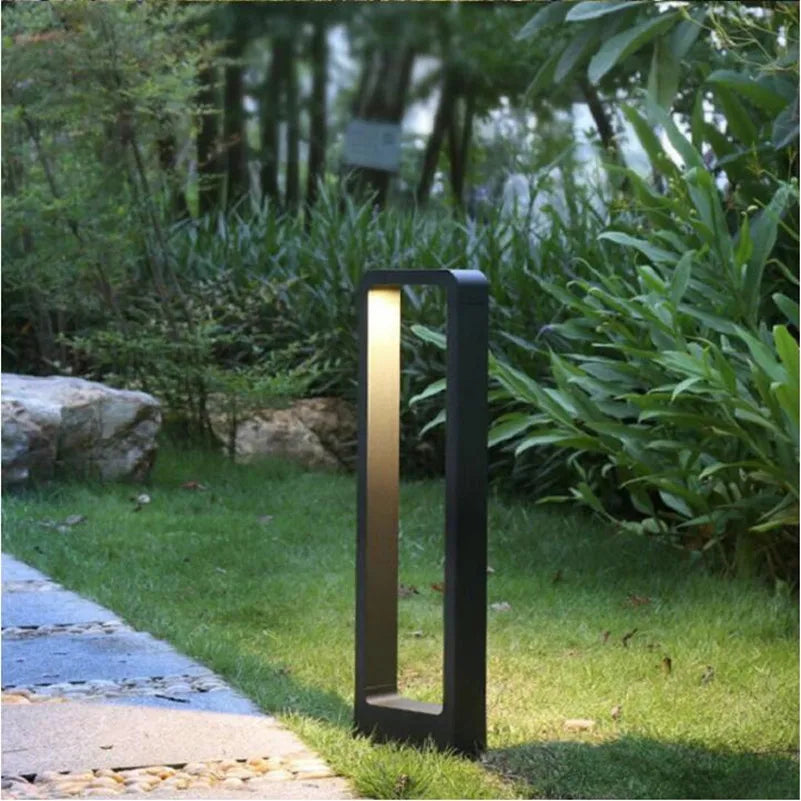Sleek LED bollard light, IP68 weatherproof, enhances yard and garden pathways with modern exterior lighting.