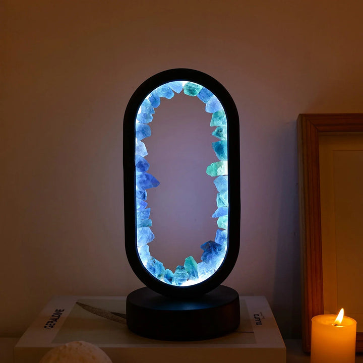 Modern oval LED table lamp with natural crystal for home office. Creates ambient light.