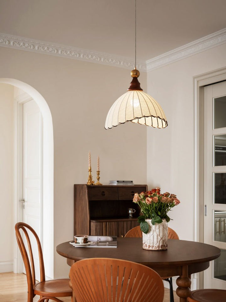 Fabric pendant light, modern & sculptural, with gold finish, suitable for home decor.