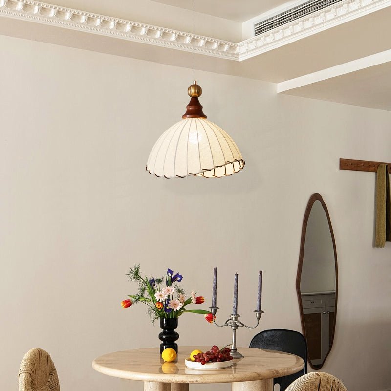 Contemporary pleated fabric pendant light, gold finish, ideal for modern interior design.