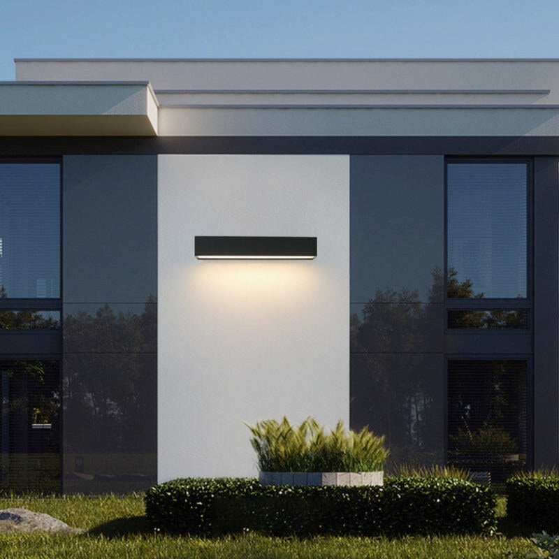 Contemporary solar LED wall light with sleek design, perfect for exterior facade & pathway illumination.