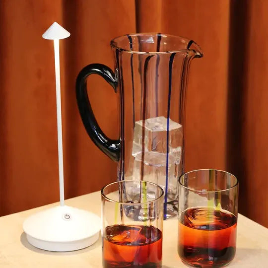 Rechargeable LED table lamp, modern & wireless. Offers dimmable, portable lighting for any room or patio.