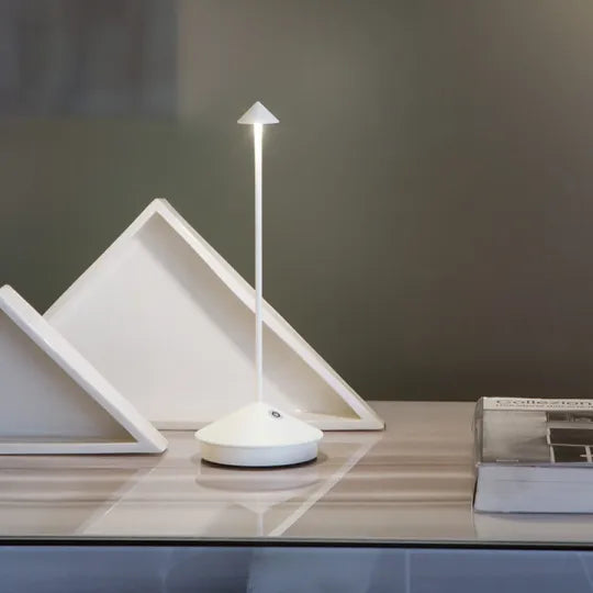 Sleek wireless LED table lamp, dimmable, rechargeable. Contemporary lighting for home, office, & outdoor use.